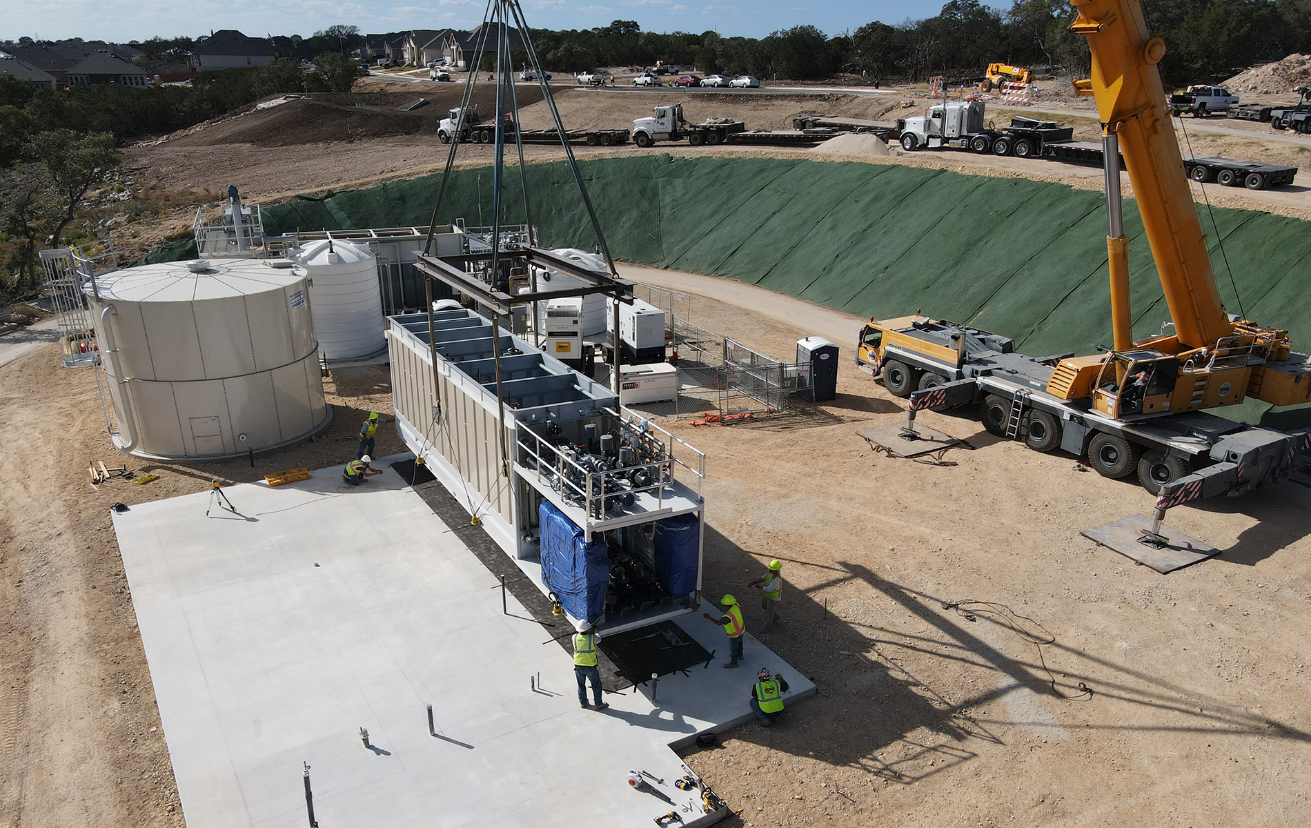Blubox MBR unit being moved into position by a construction crane | IWS | scalable wastewater solutions